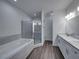 Bathroom boasts double sinks, a soaking tub, and a walk-in shower at 232 Samantha Ave, Auburndale, FL 33823