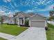 One-story home with gray siding and two-car garage at 232 Samantha Ave, Auburndale, FL 33823