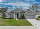 One-story home with gray siding and two-car garage at 232 Samantha Ave, Auburndale, FL 33823