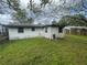 Back exterior view of a house with a small shed at 829 Wasena Ave, Lakeland, FL 33815