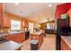 Kitchen with wood cabinets, an island, and black appliances at 4067 Sw 46Th Ter, Ocala, FL 34474