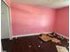Empty bedroom with pink walls and dark hardwood floors at 5018 Strada Dr, Winter Haven, FL 33880