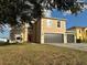Two-story house with a double garage and red door at 5018 Strada Dr, Winter Haven, FL 33880