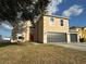 Two-story house with a double garage and red front door at 5018 Strada Dr, Winter Haven, FL 33880