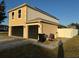 Rear view of two-story house with double garage at 5018 Strada Dr, Winter Haven, FL 33880