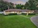 House exterior with well-maintained lawn and landscaping at 2002 Amesbury Dr, Auburndale, FL 33823