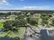 Aerial view of lakefront property with dock and lush landscaping at 2002 Amesbury Dr, Auburndale, FL 33823