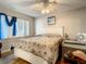 Bedroom with a ceiling fan, large bed and lots of natural light at 2002 Amesbury Dr, Auburndale, FL 33823