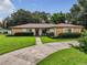 Single story home with stone facade and landscaped yard at 2002 Amesbury Dr, Auburndale, FL 33823