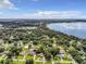 Aerial view of a residential neighborhood near a lake, showcasing many houses and yards at 2002 Amesbury Dr, Auburndale, FL 33823