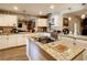 Modern kitchen with white cabinets, granite counters & island at 2002 Amesbury Dr, Auburndale, FL 33823