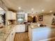 Modern kitchen with white cabinets, granite counters & island at 2002 Amesbury Dr, Auburndale, FL 33823