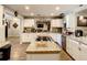 Modern kitchen with white cabinets, granite counters & island at 2002 Amesbury Dr, Auburndale, FL 33823