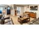 Living room with dark leather sofas and wood floors at 2002 Amesbury Dr, Auburndale, FL 33823