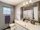 Bathroom with single vanity, shower/tub combo, and updated flooring at 2002 Amesbury Dr, Auburndale, FL 33823