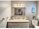 Vanity with mirror and storage in guest bathroom at 2002 Amesbury Dr, Auburndale, FL 33823