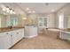 Elegant bathroom featuring a soaking tub, walk-in shower, and granite countertops at 3366 Cat Brier Trl, Harmony, FL 34773