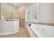 Spa-like bathroom with a large soaking tub and walk-in shower at 3366 Cat Brier Trl, Harmony, FL 34773