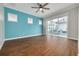 Bright bedroom with pool view, hardwood floors and blue accent wall at 3366 Cat Brier Trl, Harmony, FL 34773