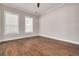 Spacious bedroom with hardwood floors and two large windows at 3366 Cat Brier Trl, Harmony, FL 34773