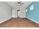 Spacious bedroom with hardwood floors and a view of the en-suite bathroom at 3366 Cat Brier Trl, Harmony, FL 34773