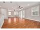 Spacious bonus room with hardwood floors, access to balcony, and multiple ceiling fans at 3366 Cat Brier Trl, Harmony, FL 34773