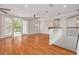 Large bonus room with hardwood floors, double doors leading to a balcony, and ceiling fans at 3366 Cat Brier Trl, Harmony, FL 34773