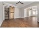 Spacious dining room with hardwood floors and barn door leading to a wine storage area at 3366 Cat Brier Trl, Harmony, FL 34773