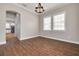 Dining room features hardwood floors and a chandelier at 3366 Cat Brier Trl, Harmony, FL 34773