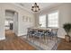 Elegant dining room with hardwood floors, chandelier, and modern table set at 3366 Cat Brier Trl, Harmony, FL 34773