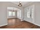 Elegant entryway with hardwood floors, chandelier, and white door at 3366 Cat Brier Trl, Harmony, FL 34773