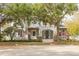 Two-story house with gray siding, stone accents, and a tree-lined street at 3366 Cat Brier Trl, Harmony, FL 34773