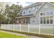 House exterior with white picket fence and stone accents at 3366 Cat Brier Trl, Harmony, FL 34773