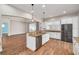 Spacious kitchen with island, stainless steel appliances, and granite countertops at 3366 Cat Brier Trl, Harmony, FL 34773