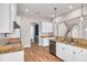 Modern kitchen features white cabinets, granite countertops, and stainless steel appliances at 3366 Cat Brier Trl, Harmony, FL 34773