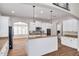 Modern kitchen with white cabinets, granite countertops, and stainless steel appliances at 3366 Cat Brier Trl, Harmony, FL 34773