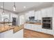 Modern kitchen with white cabinets, granite countertops, and stainless steel appliances at 3366 Cat Brier Trl, Harmony, FL 34773