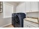 Bright laundry room with washer, dryer, and ample storage at 3366 Cat Brier Trl, Harmony, FL 34773