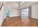Spacious living room with hardwood floors, high ceilings, and sliding glass doors at 3366 Cat Brier Trl, Harmony, FL 34773