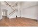 Open living area with hardwood floors and a grand staircase at 3366 Cat Brier Trl, Harmony, FL 34773