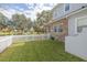 Side yard with white picket fence and access to street at 3366 Cat Brier Trl, Harmony, FL 34773