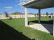 Spacious backyard with grassy area and covered patio at 148 Summerlin Loop, Haines City, FL 33844