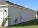 Side view showcasing house exterior and landscaping at 148 Summerlin Loop, Haines City, FL 33844