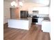 Modern kitchen with island, stainless steel appliances, and granite countertops at 148 Summerlin Loop, Haines City, FL 33844