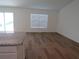 Bright living room with laminate wood flooring and large window at 148 Summerlin Loop, Haines City, FL 33844