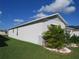 Single-story house with gray siding, landscaping, and a palm tree at 148 Summerlin Loop, Haines City, FL 33844