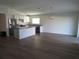 Open concept kitchen and dining area with light wood floors at 148 Summerlin Loop, Haines City, FL 33844