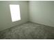 Bright bedroom with neutral carpeting and large window at 148 Summerlin Loop, Haines City, FL 33844
