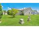 Large backyard with grassy lawn and mature trees at 2572 Berrington Loop, The Villages, FL 32162