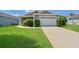 Well-maintained house with a two-car garage and spacious lawn at 2572 Berrington Loop, The Villages, FL 32162